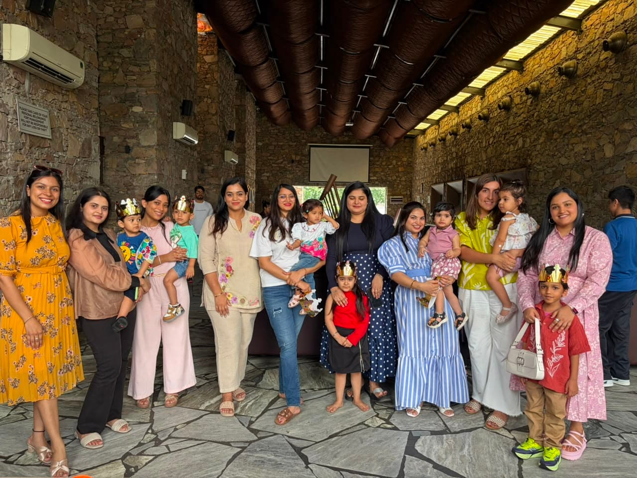 Happy families wearing paper crowns at a Play & Pause session in Jaipur